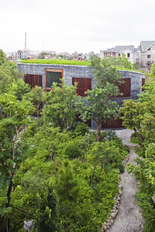 
Mặt ngoài của ngôi nhà được xử lý bằng thanh chấn gỗ và cây xanh.
