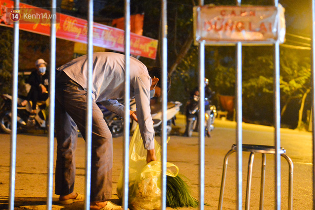Ảnh: Đường vào thôn bị phong toả, người dân Mê Linh chuyển hàng tạ rau qua chốt kiểm dịch y tế trong đêm - Ảnh 8.