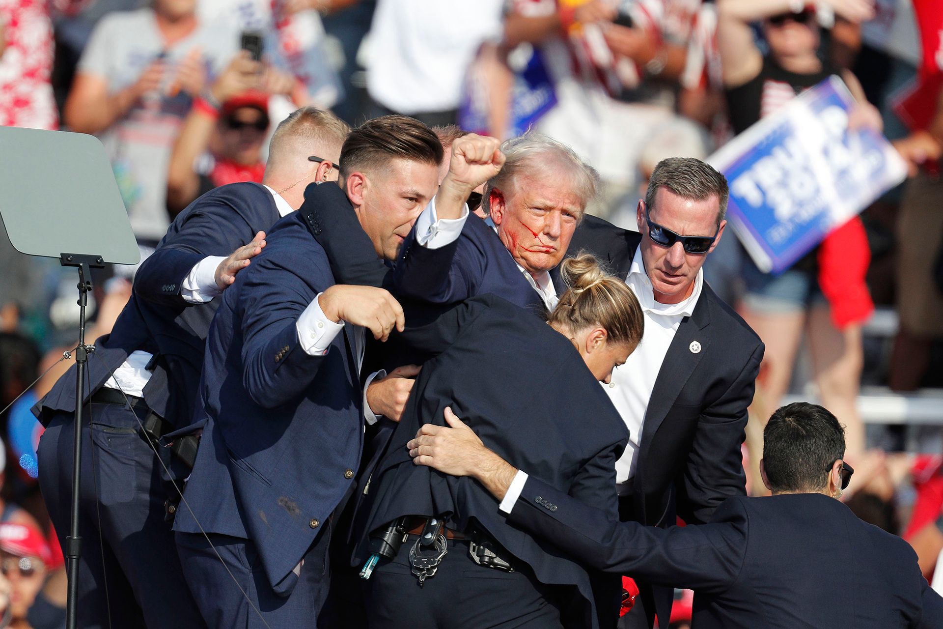 Former US president and Republican candidate Donald Trump being rushed offstage by Secret Service agents after he was shot in the ear in an assassination attempt at a campaign rally in Butler, Pennsylvania. Trump later won the 2024 presidential election.  PHOTO: EPA-EFE