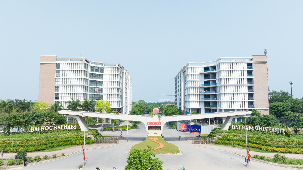 A bridge over a road with buildings in the background Description automatically generated