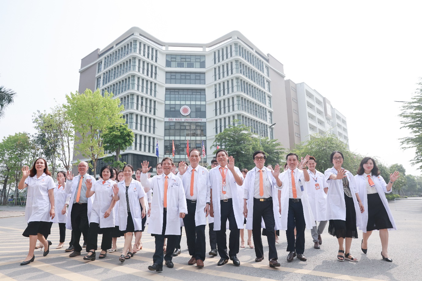 A group of people in white coats Description automatically generated