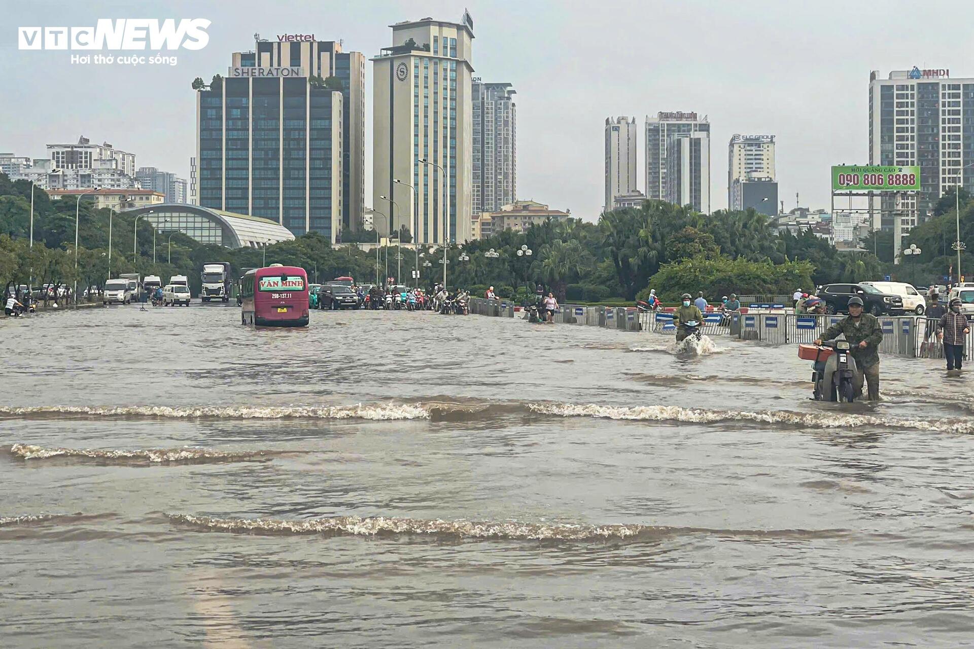 Đường vẫn ngập ngang gối, dân Hà Nội chen chúc dắt xe lội nước đi làm từ sớm Đường vẫn ngập ngang gối, dân Hà Nội chen chúc dắt xe lội nước đi làm từ sớm
