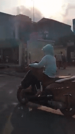 Ninja lead ngồi vắt chân khi đang chạy xe trên đường. Ảnh cắt từ clip: Nguyễn Phương Linh.