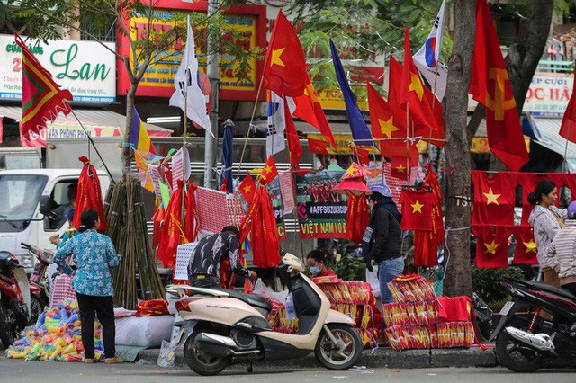 Người TP HCM nườm nượp mua sẵn cờ, áo đỏ cổ vũ tuyển Việt Nam - Ảnh 1.