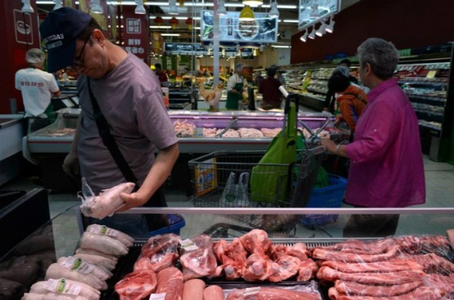 Vui buồn thịt lợn tại Trung Quốc trong tuần lễ vàng - Ảnh 1.