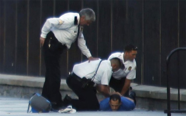Nhân viên Mật vụ Mỹ bắt giữ một người đàn ông bị cho là ném pháo hoa qua hàng rào Nhà Trắng hôm 16/9/2013.