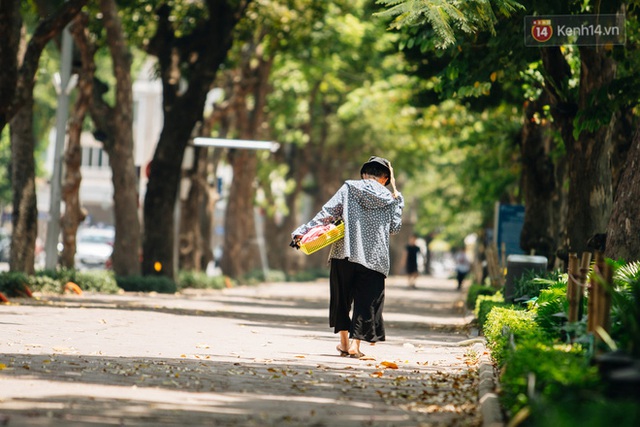 Ảnh: Nhiệt độ ngoài đường tại Hà Nội lên tới 50 độ C, người dân trùm khăn áo kín mít di chuyển trên phố - Ảnh 8.