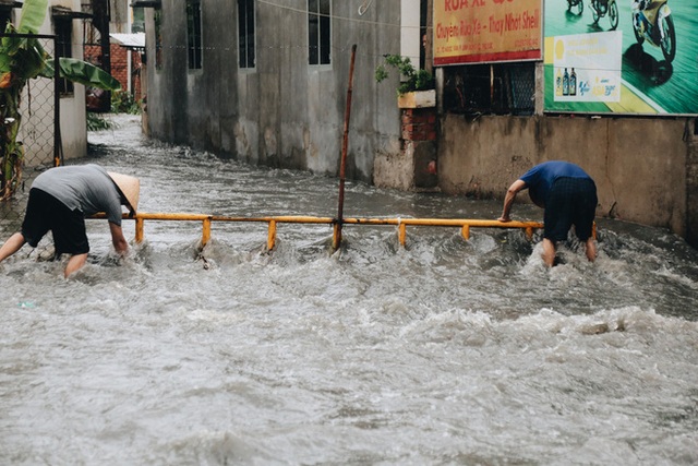 Ảnh: Đường Sài Gòn ngập lút bánh xe khi mưa lớn, người dân té ngã sõng soài - Ảnh 7.