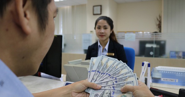 Khách hàng giao dịch kiều hối tại một ngân hàng trên đường Nguyễn Thị Minh Khai, quận 3, TP.HCM - Ảnh: NGỌC PHƯỢNG