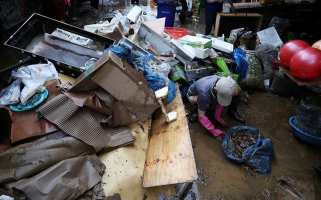 Người dân ở Seoul, Hàn Quốc, dọn rác sau trận mưa kinh hoàng ngày 9-8 - Ảnh: REUTERS
