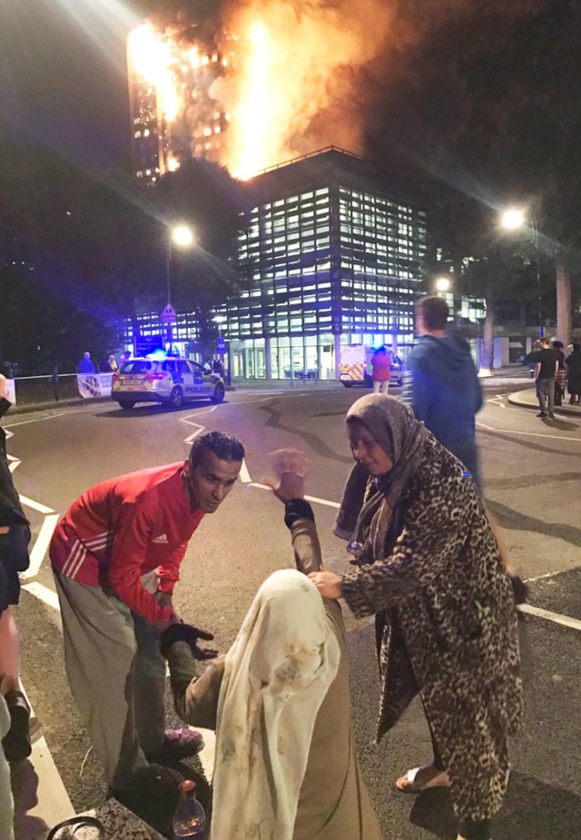 Hình ảnh người còn sống mắc kẹt bên trong tòa nhà 27 tầng bị lửa bao trùm, nhiều người được xác nhận đã chết - Ảnh 9.