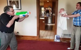 Linh mục dùng súng phun nước để rửa tội cho em bé trong mùa dịch COVID-19